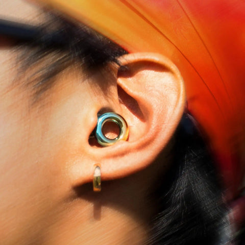 Person wearing Experience 2 Ear Plugs For Concerts And Festivals With High Fidelity Sound And 17dB Noise Reduction in ear close-up