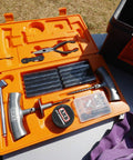 Open case of Speedy Seal 2 Universal Heavy Duty Tire Repair Kit with tools and 40 vulcanizing cords on grass surface