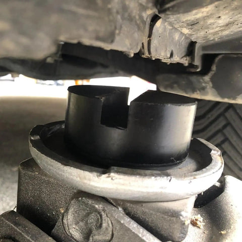 Close-up of Two Pack Rubber Jack Pads for Floor Jack Stands, Heavy Duty Slotted Frame Rail Protectors on car lift.