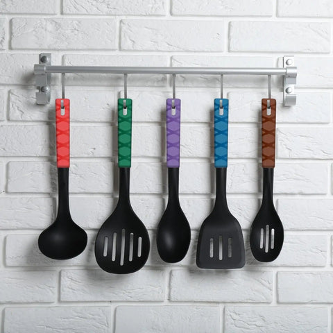 Five colorful kitchen spatulas hanging on a rack, featuring solid black heads and vibrant handles in red, green, purple, blue, and brown.