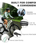 Woman riding Women’s 26 Inch Mountain Bike For Adults With Shimano Rear Derailleur And Twist Grip Shifter 21 Speed Shifting Dual Disc Brakes Lockout Suspension Two Point Three Five Inch Tires Steel Frame Eighty Five Percent Preassembled White on wet road