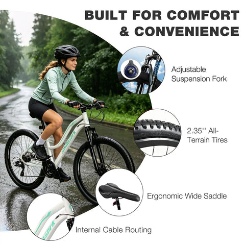 Woman riding Women’s 26 Inch Mountain Bike For Adults With Shimano Rear Derailleur And Twist Grip Shifter 21 Speed Shifting Dual Disc Brakes Lockout Suspension Two Point Three Five Inch Tires Steel Frame Eighty Five Percent Preassembled White on wet road