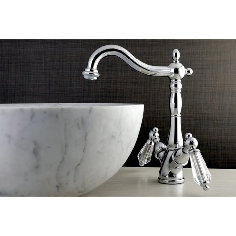 KS1491WLL Sleek Wilshire Vessel Sink Faucet Polished Chrome With Deck Mount next to a marble vessel sink on vanity deck
