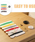 Real Deal Mini Sewing Kit With 200 Pieces As A Portable Travel Set To Mend Clothes On The Fly While Backpacking Commuting Or Just Taking It Easy On Any Long Weekend Trip, featuring colorful threads, buttons, and safety pin on a wooden table.