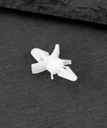 Top Shelf 100 Count White Pcb Standoff Mounting Clips Quick Snap Fit For 4Mm Holes on black surface, showing installation detail.