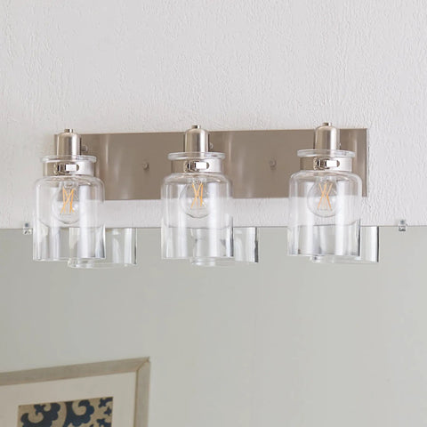 Calhoun Collection Clear Glass Farmhouse Bath Vanity Light Three Light Brushed Nickel Vintage Inspired Fixture mounted on wall