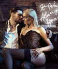 Couple embracing on sofa with 'It Was Always You' neon sign glowing in background, creating a romantic atmosphere.