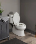 Zero Fuss Potty Training Toilet Seat For The Whole Fam With Built In Magnetic Toddler Cup And Slow Close Lid Steady Hold Elongated Style Crisp White Bathroom Essential in modern bathroom setting.