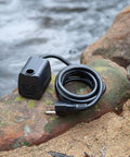 M160AUL Submersible Fountain Pump on rock near water, coiled cable visible