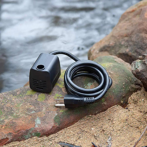 M160AUL Submersible Fountain Pump on rock near water, coiled cable visible