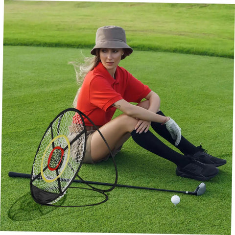 Person with Dope Golf Chipping Net With Ball Return System And Hitting Mat For Backyard Practice next to golf clubs on grass