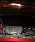 Rechargeable Portable COB LED And UV Work Light illuminating an open car engine bay with 1000 Lumens USB C Cordless Drop Light.