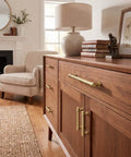 Top Tier Brushed Brass Cabinet Pulls 10 Pack Featuring 96MM Hole Spacing on a stylish wooden sideboard.