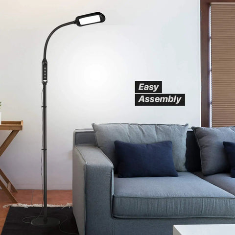 2 In 1 LED Floor And Desk Lamp With Adjustable Height And Gooseneck next to a grey sofa, showing easy assembly feature.