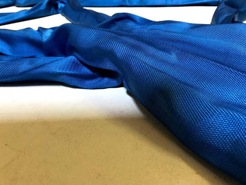 Close-up of Blue 10 Ft Endless Round Sling 21200 Lb Vertical WLL And 42400 Lb Basket Capacity on light surface