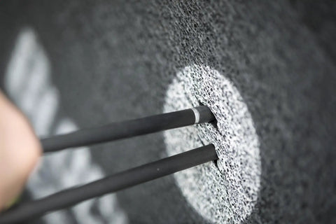 Close-up of arrows penetrating the Open Archery Target for Youth 16 Inch With 40 Lb Draw Compatibility, foam core surface visible