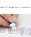 Triangle eraser being used to erase a grid on a sheet, focuses on precise removal of pencil markings with Ultimate Drafting Pencil Set.