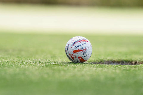 SpeedSoft Ink USA Dozen Soft Golf Ball with Ultra Low Compression PWRCORE Technology on green near hole