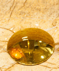 Water droplet on a countertop near a Ceramic Vessel Sink,16.5"x5.9"Round Vessel Sink Marbling Vessel Sink Bathroom Sinks.