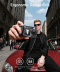 Man holding Metal Street Grip Kit For DJI Action 5 Pro 4 3 with cage, quick release handle grip, DSLR-like stability in city street.