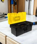 Badass Plastic Toolbox With Lockable Buckles And Removable Tray Plus Sure Grip Carry Handle For Go Anywhere Tool Holding and Straight Up Reliable Home Project Storage Cases, black and yellow, open on a workbench.