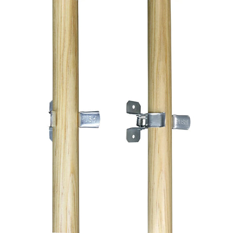 Close-up of Ten Pack Wall Mount Organizing Spring Clamps For Tools, Rakes And Brooms With Handy Multi Tool Holder in use on wooden poles.
