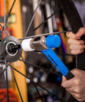 Double Face Rubber Mallet 12 Oz With White Nylon Head And Blue Soft Face, used on bike wheel, graphite core handle visible