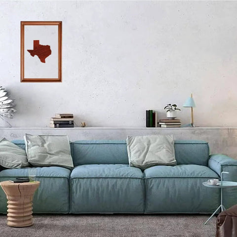 Living room with a blue sofa, wood art depicting Texas on the wall above, showcasing the use of United States Router Template Set Clear Acrylic Inlay Template For Woodworking State Map Jig For Tracing Crafting And Inlay Guides Reusable Durable Template For Texas And Other States.