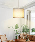 Slick Adjustable Plug In Pendant Light With Authentic Beige Linen Shade hanging in a cozy living room with plants and furniture.