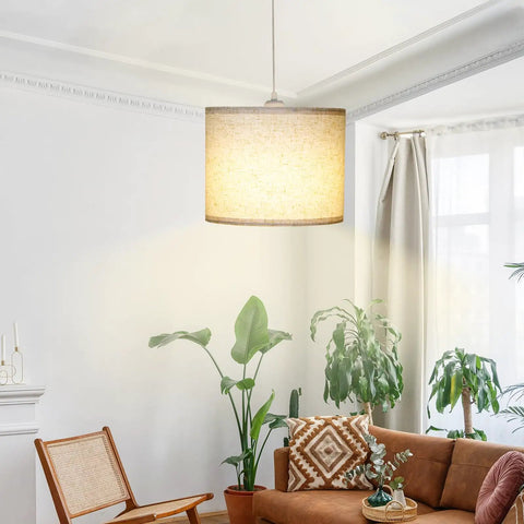 Slick Adjustable Plug In Pendant Light With Authentic Beige Linen Shade hanging in a cozy living room with plants and furniture.