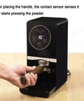 Next Level Electric Coffee Tamper 58mm Semi Automatic Espresso Press With Smart Contact Sensor adjusting pressure on coffee grounds.