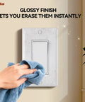 Cleaning a glossy 1-Gang Standard Light Switch Cover Plate in glossy white made from unbreakable polycarbonate installed on wall.