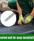 Person installing Heavy Duty 50 Pack Four Inch Landscape Staples Galvanized Ground Stakes for weed barriers on landscaping fabric.