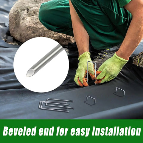 Person installing Heavy Duty 50 Pack Four Inch Landscape Staples Galvanized Ground Stakes for weed barriers on landscaping fabric.