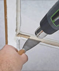 Genesis GHG1500A Dual Temperature Heat Gun Kit used with scraper on window frame for paint removal