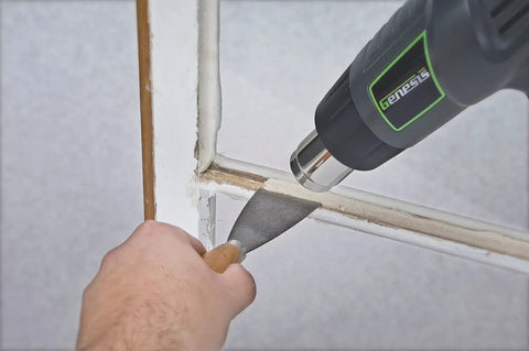 Genesis GHG1500A Dual Temperature Heat Gun Kit used with scraper on window frame for paint removal