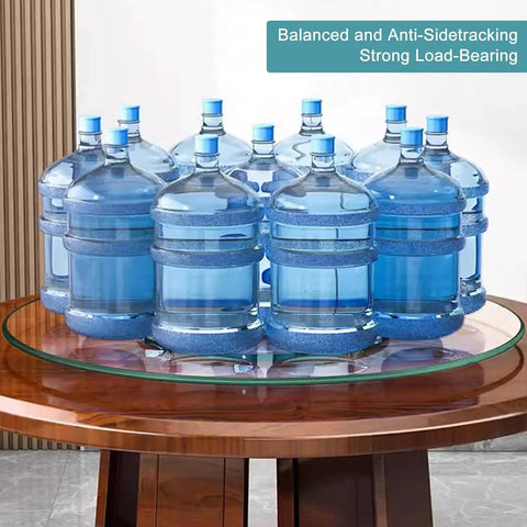 Heavy Duty Round Tempered Glass Lazy Susan With Swivel Assist Mechanism Hassle Free 360 Degree Rotation Serving Turntable displaying multiple water bottles.