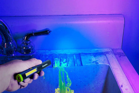 Rechargeable Inspection Pen Light With 450 Lumen Flood And 140 Lumen Spot, 365 Nm UV Light illuminating a bathroom sink.