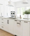 Modern white kitchen with 30 pack 5 inch matte black cabinet pulls square stainless steel drawer handles for cabinets and drawers.