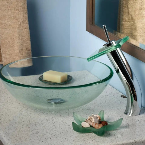 Squared Single Lever Waterfall Vessel Faucet With Pop Up Drain In Chrome Clear Glass Finish next to round glass sink