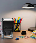 Heavy Duty Self Inking Date Stamp With Custom Message And Signature Replaceable Dual Color Ink Pad For Office Paperworks on a desk with papers and clips.