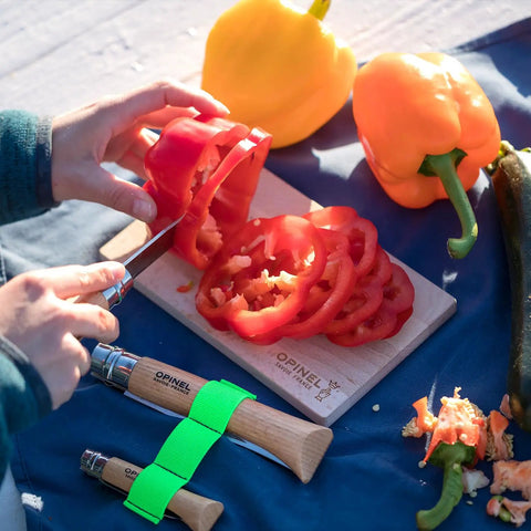 Nomad Camping Kitchen Utensil Kit With Serrated No 12 Folding Knife slicing red pepper on cutting board