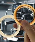 54Mm Silicone Steam Ring For Espresso Machines Barista Grade Grouphead Gasket Replacement Compatible With Breville And Sage Models 878 870 860 880 810 840 450 500 And 875 BPA Free Heat Resistant being held in front of espresso machine