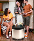 People enjoying the Smokeless Fire Pit Accessories Set For Outdoor Hangouts And Backyard Chill next to a camper.