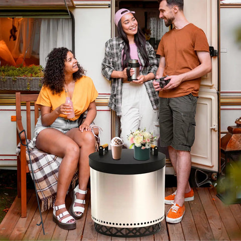 People enjoying the Smokeless Fire Pit Accessories Set For Outdoor Hangouts And Backyard Chill next to a camper.