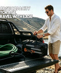 Man loading Heavy Duty Battery Powered Stick Water Pump With Three Speed Adjustable Motor into a truck for easy transport.