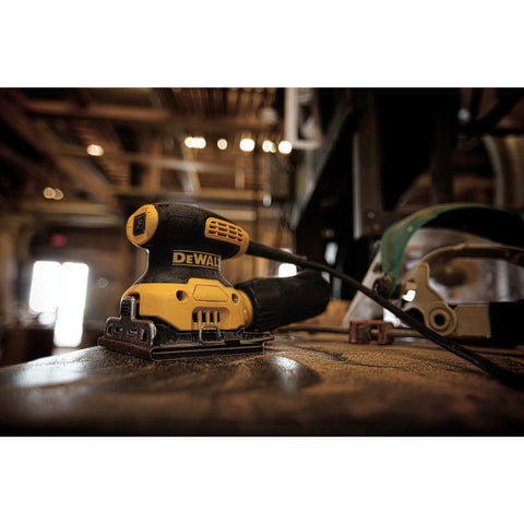 Grab And Go Palm Sander 1/4 Sheet, 14,000 OPM, 2.3 Amp Electric Sander with rubber overmold grip on a workshop table