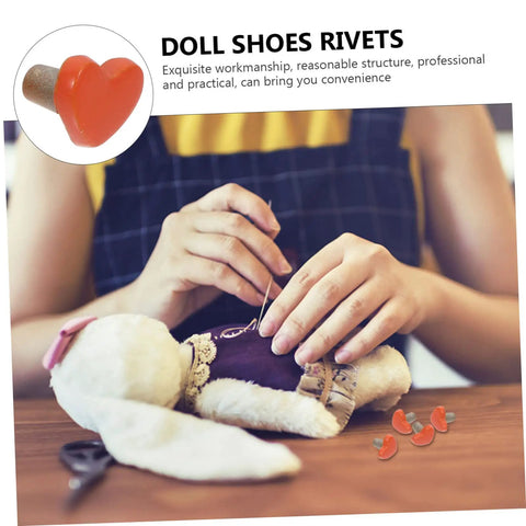 Person using 100 Pieces Heart Shaped Mini Doll Rivets For DIY Doll Clothes Fasteners on doll clothing.