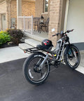 Tough As Nails Dual Motor Fat Tire Electric Bike For Adults in driveway, featuring full suspension and cargo rack.