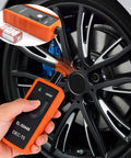 TPMS Relearn Tool For Cars And Trucks, Tire Pressure Monitor Sensor Activation And Reset Programmer For Chevrolet Cadillac Buick And Most Models 2006 To 2024, Easy Plug In Orange held by hand near wheel